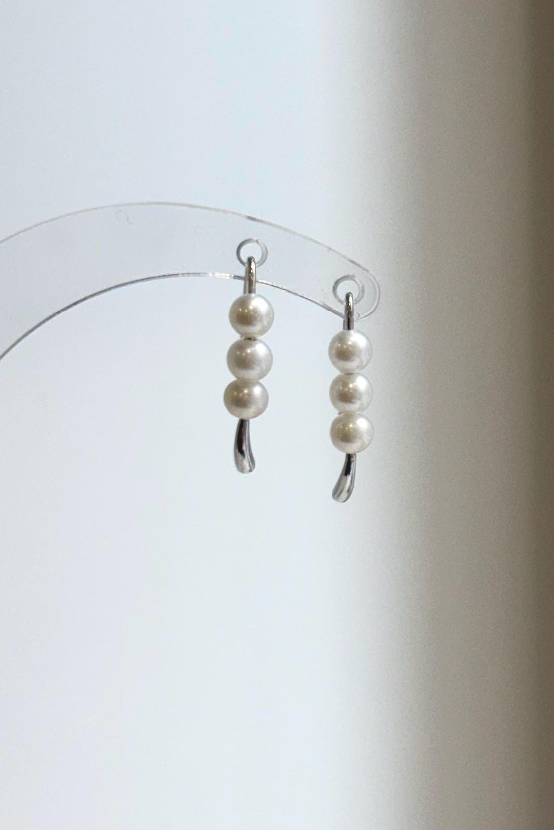 Lustrous white pearls paired with sleek S925 sterling silver curves.