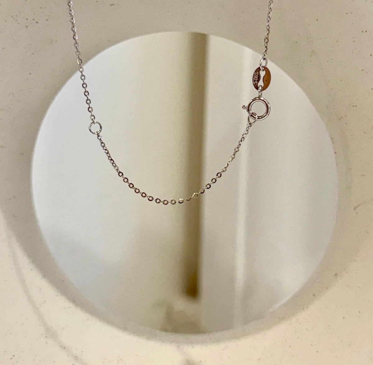 Elegant ocean pearl necklace with a prominent pearl centerpiece.