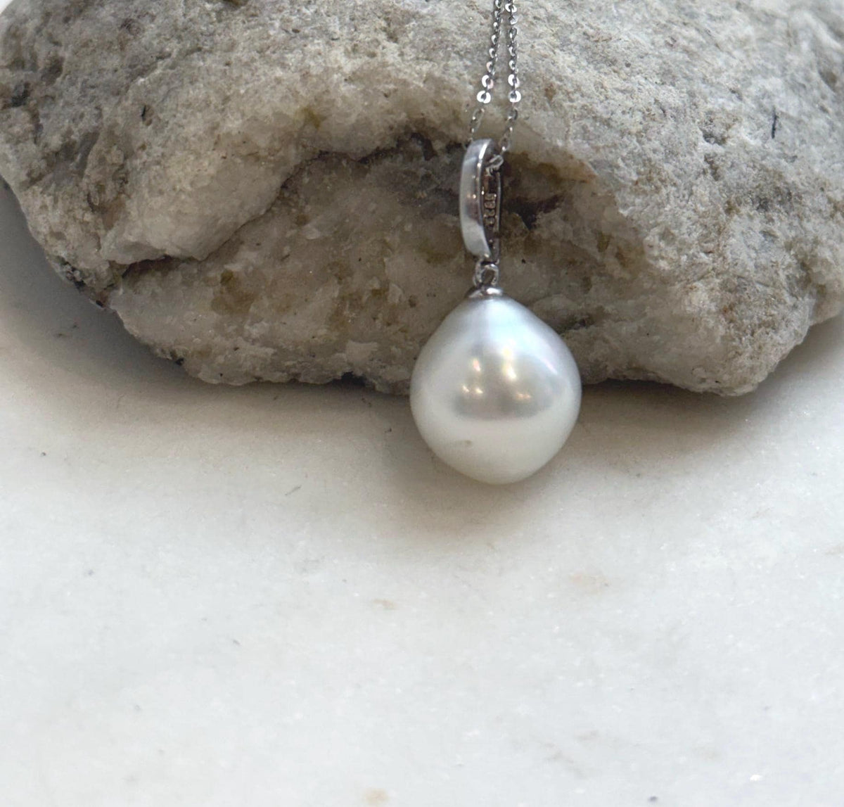 Lustrous ocean pearl pendant on a sterling silver necklace.