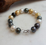 Golden, white and peacock ocean pearl bracelet.