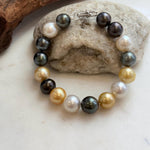 Dark ocean pearls reflecting green and blue overtones.