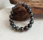 Tahitian pearl bracelet with hunter green and platinum tones.