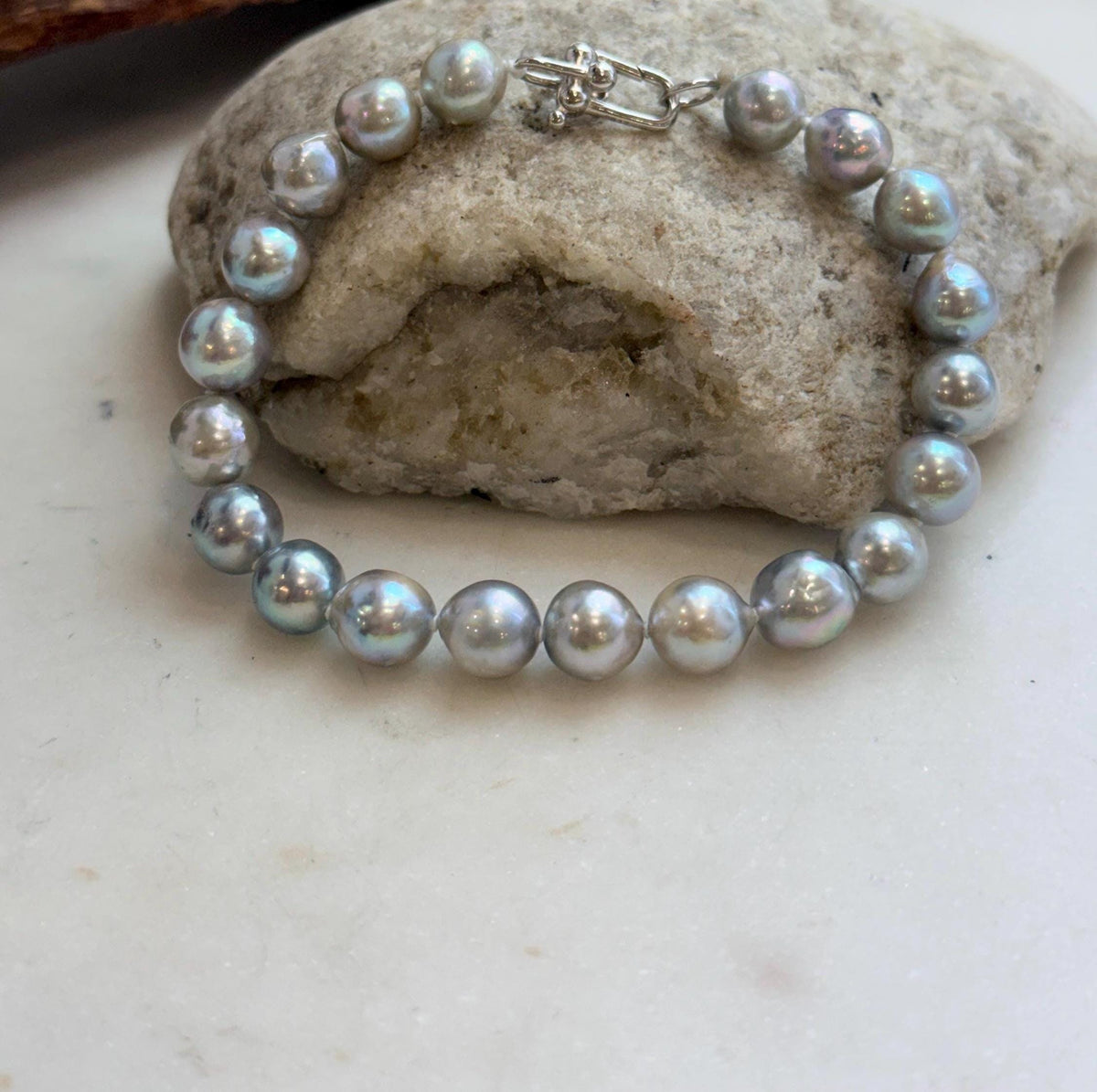 Lustrous Japanese Akoya pearls paired with a sterling silver clasp.