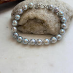 Lustrous Japanese Akoya pearls paired with a sterling silver clasp.