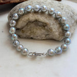 Classic Akoya pearl bracelet with a polished silver clasp.