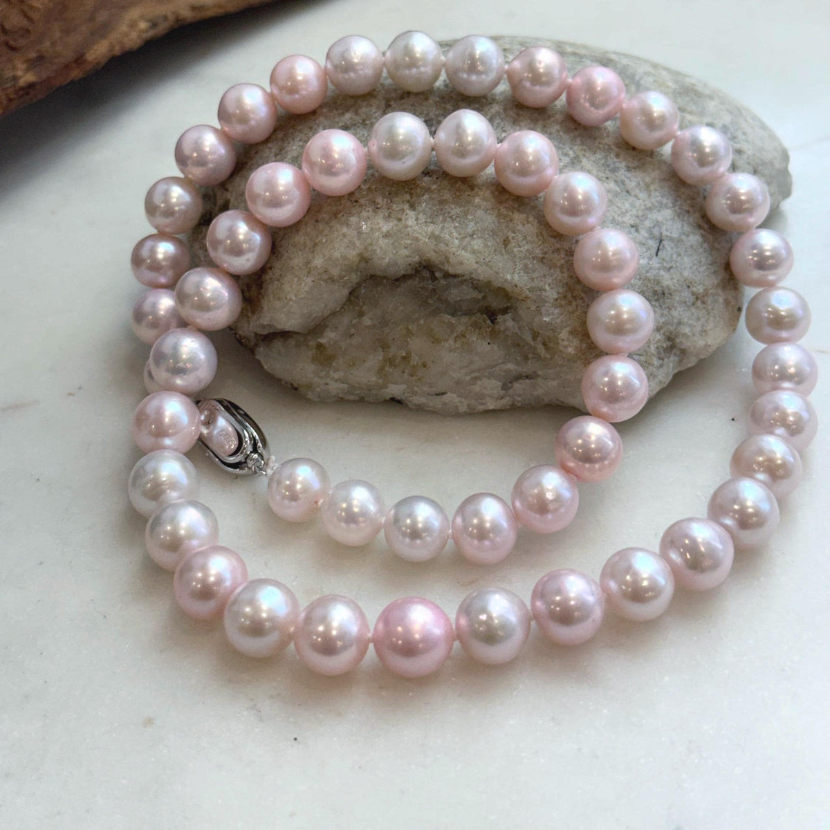 Lustrous pale pink pearls on a hand-knotted necklace.