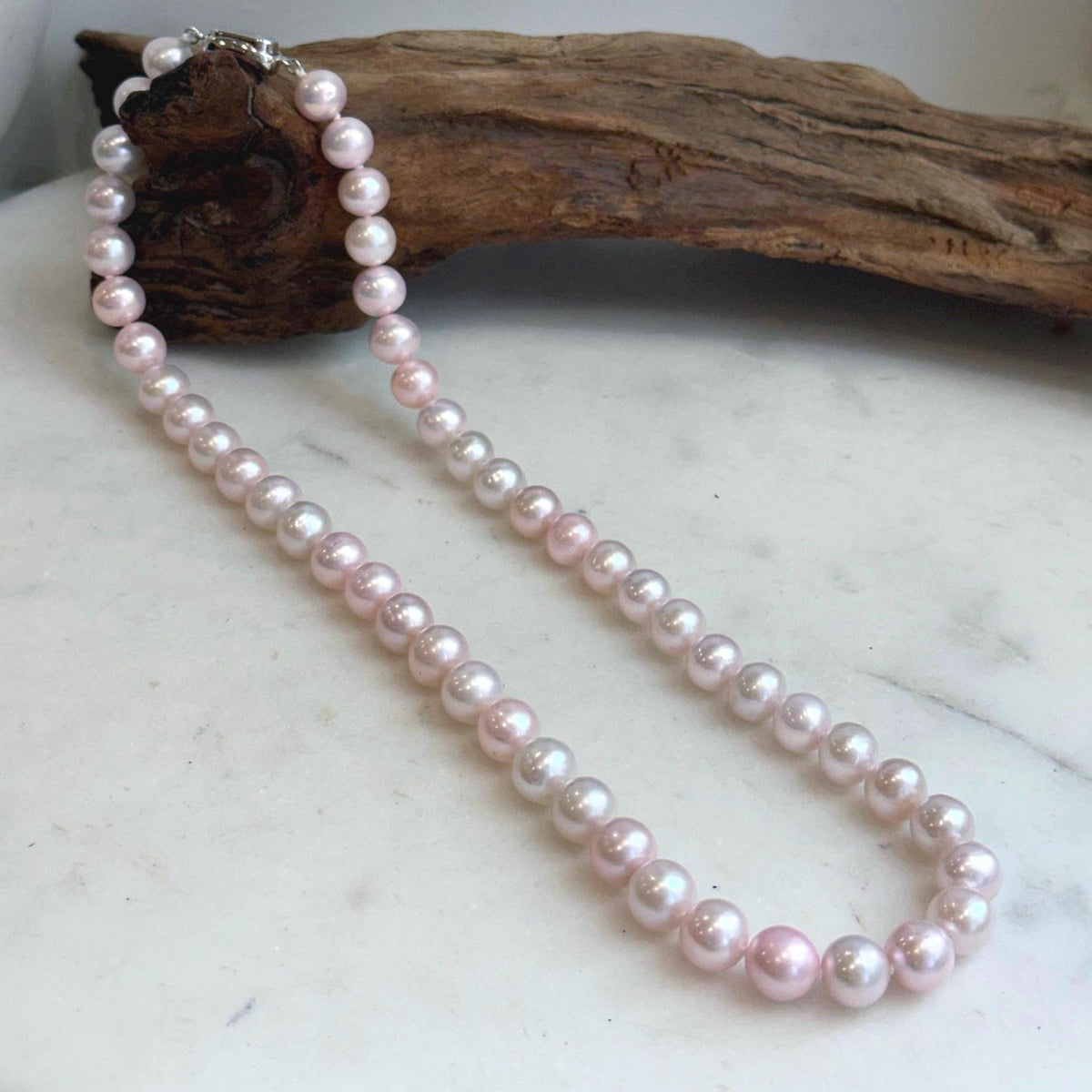 Genuine freshwater pearl strand with soft pink tones.