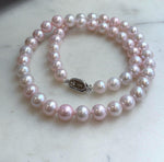 Lustrous freshwater pearl necklace with a soft pink hue.