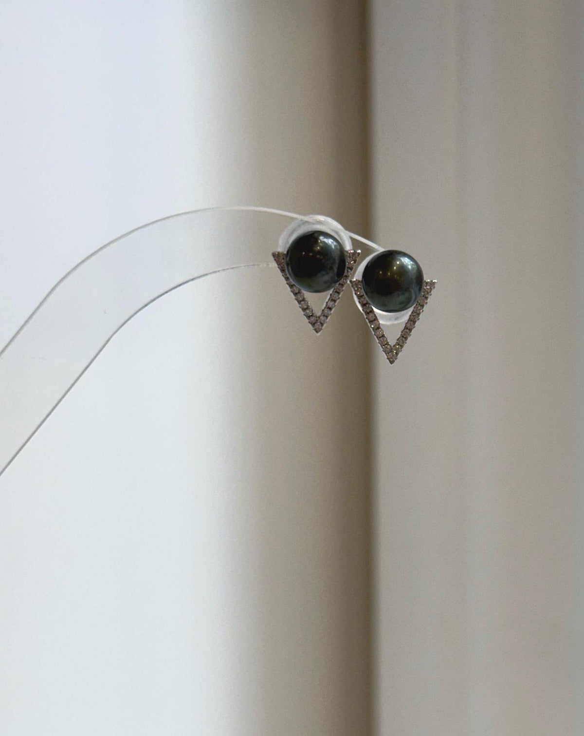 Hunter green pearl studs with mirror luster and open triangle details.
