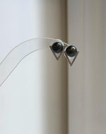 Hunter green pearl studs with mirror luster and open triangle details.