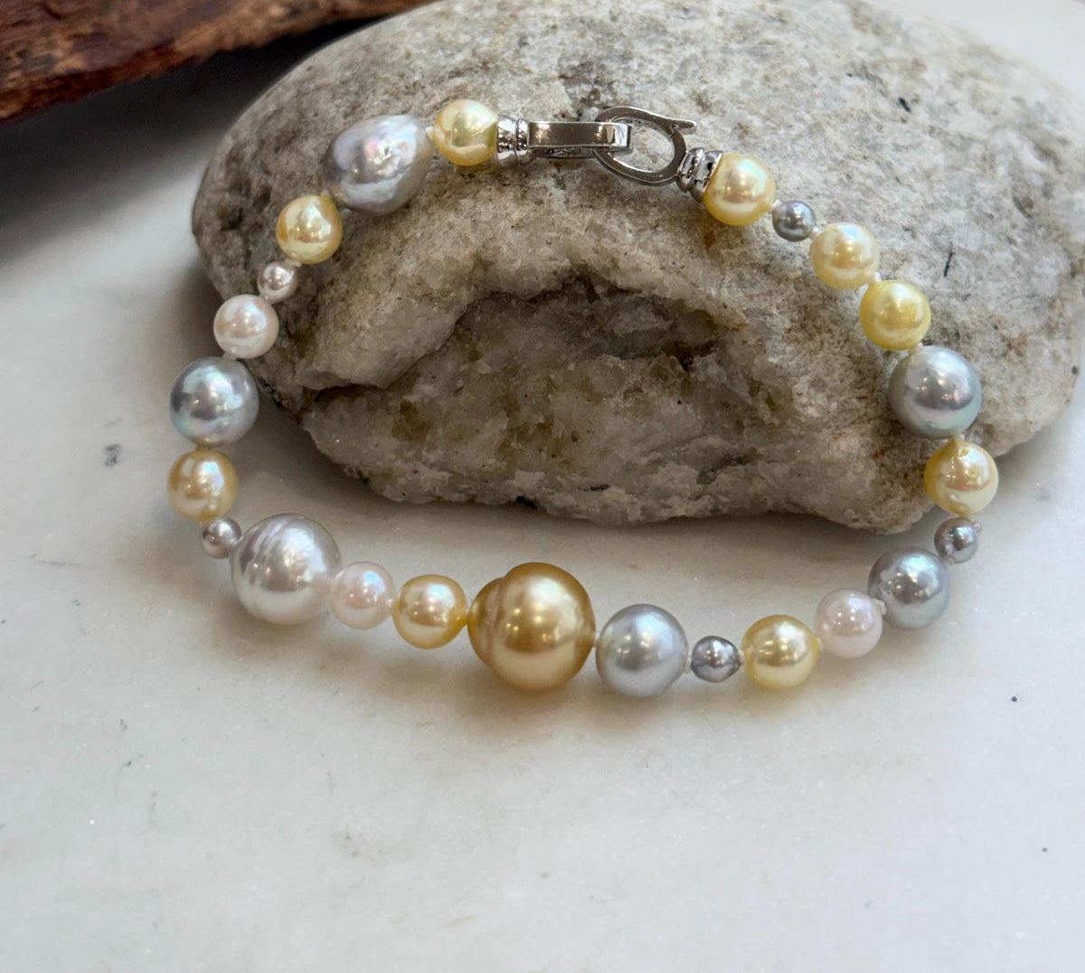 Elly’s multicolor saltwater pearl bracelet with hand-knotted construction and sterling silver fastening.