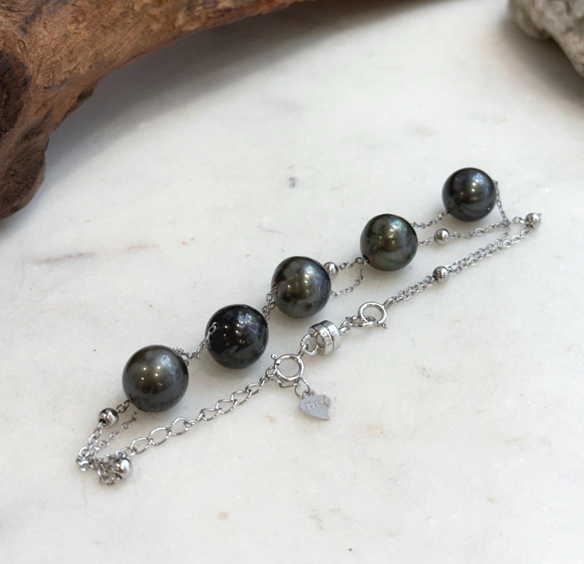 Five genuine Tahitian saltwater pearls spaced along a delicate S925 silver chain.