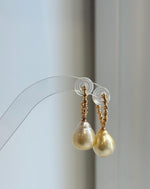 Ultra golden pearl earrings with mirror luster and silver hooks.