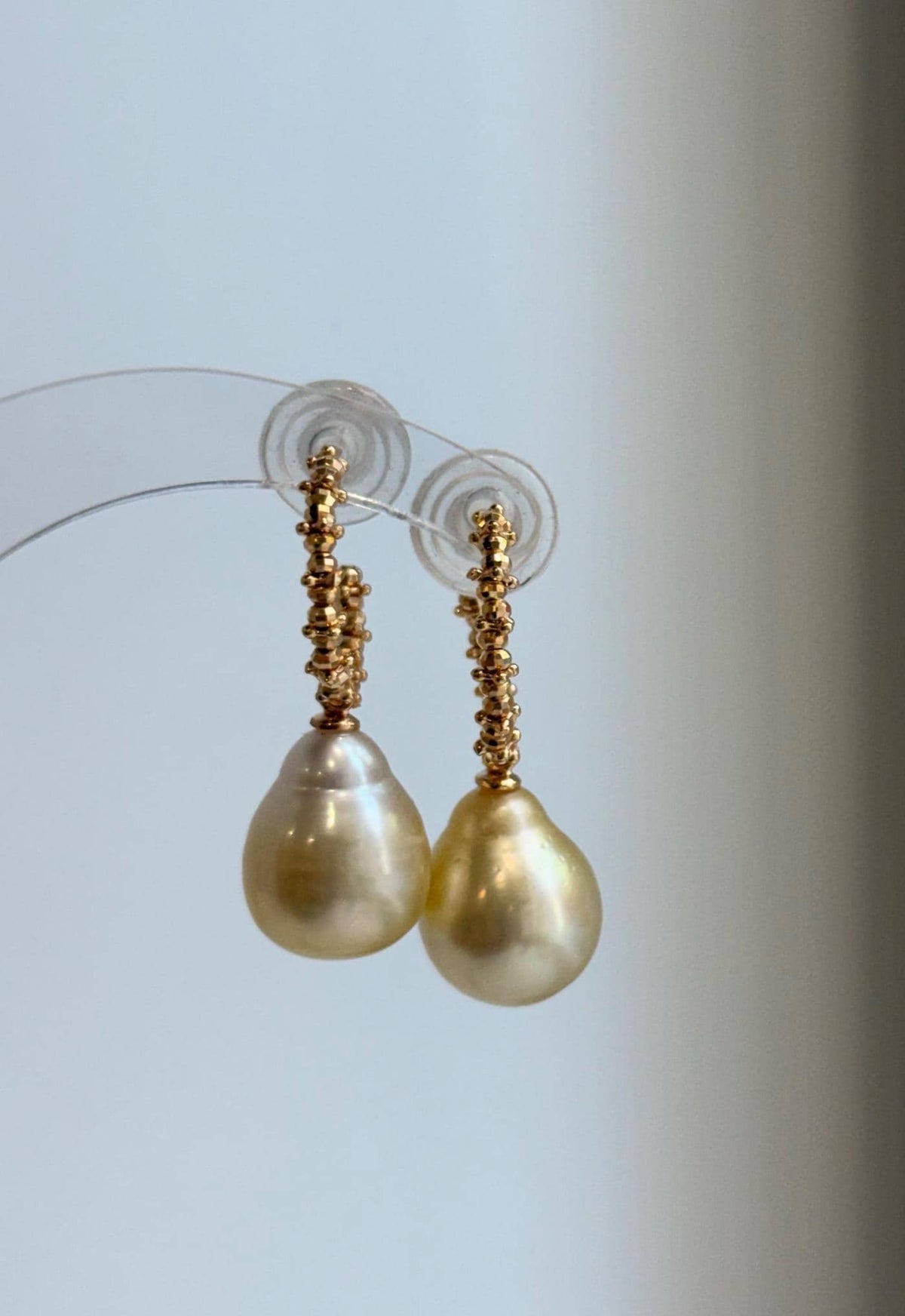 Golden pearl drop earrings featuring S925 sterling silver hooks.