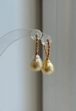 Ultra golden saltwater pearls in a sterling silver drop earring design.