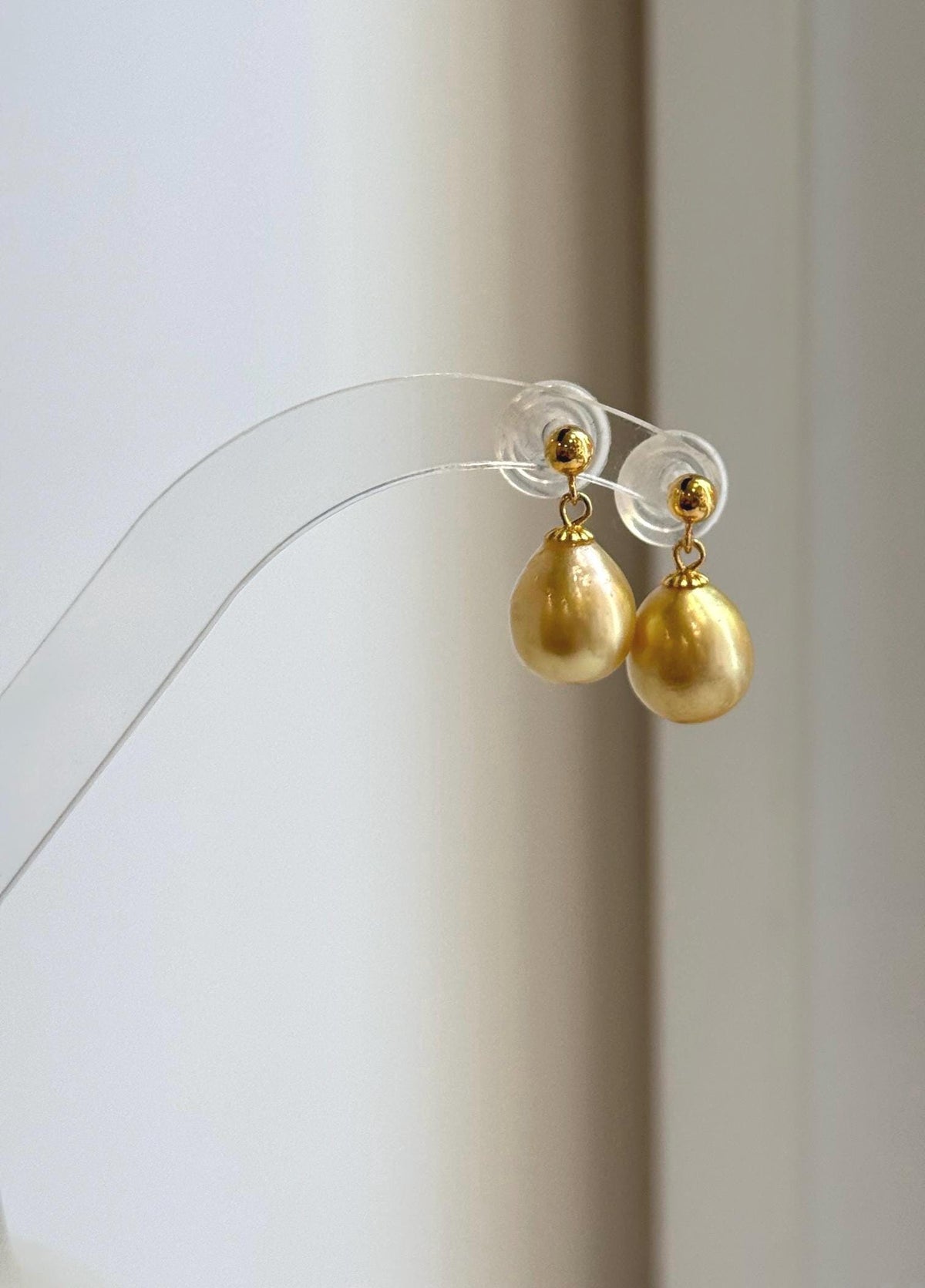 Golden South Sea pearl drop earrings with gold-tone ball studs.