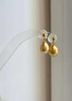 Golden South Sea pearl drop earrings with gold-tone ball studs.