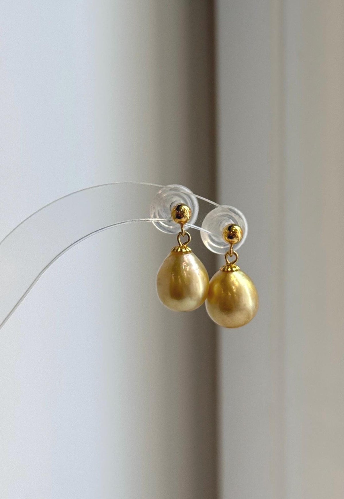 South Sea pearl earrings with warm golden tones and reflective luster.