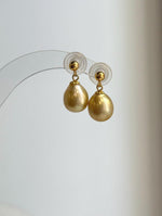 S925 sterling silver earrings featuring genuine golden South Sea pearls.