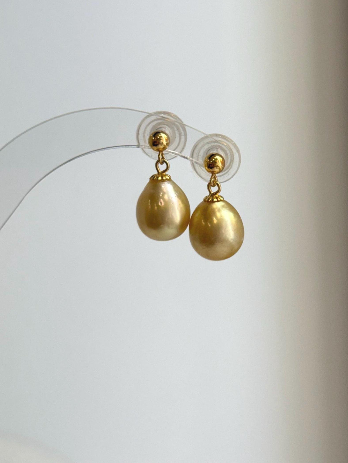 S925 sterling silver earrings featuring genuine golden South Sea pearls.