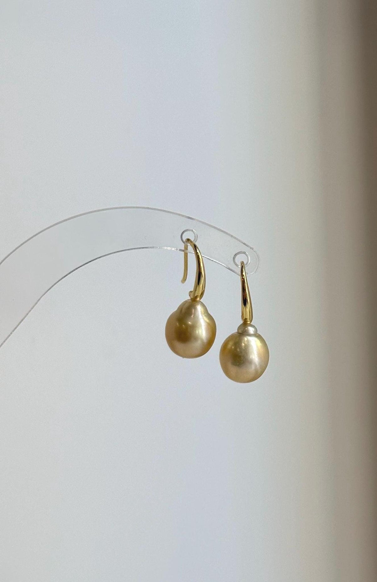 Gold-tone S925 silver hooks paired with lustrous golden South Sea pearls.