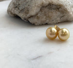 Golden pearl earrings with distinctive high-heel style S925 silver hooks.
