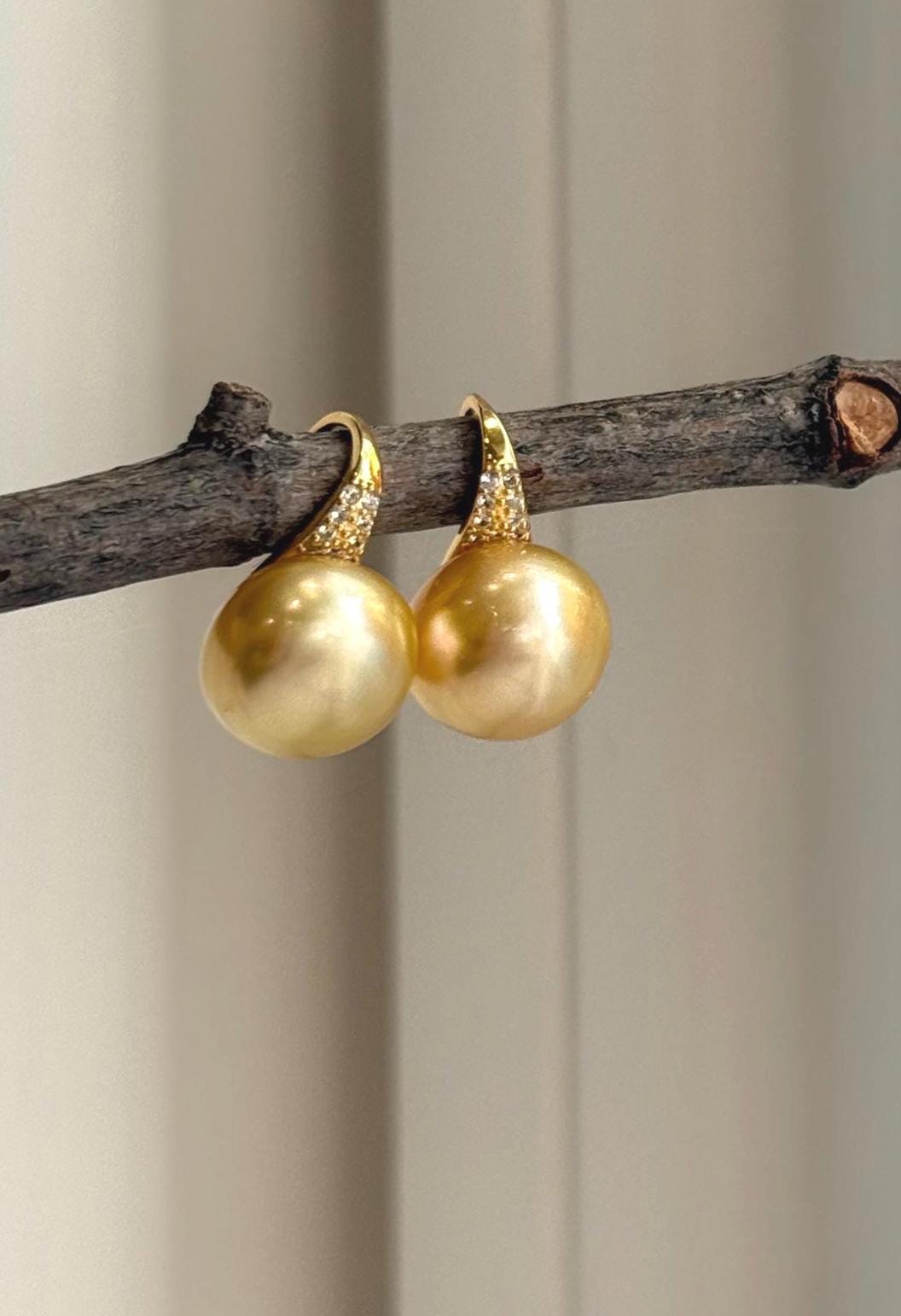 Lustrous South Sea pearls paired with sculptural sterling silver ear hooks.