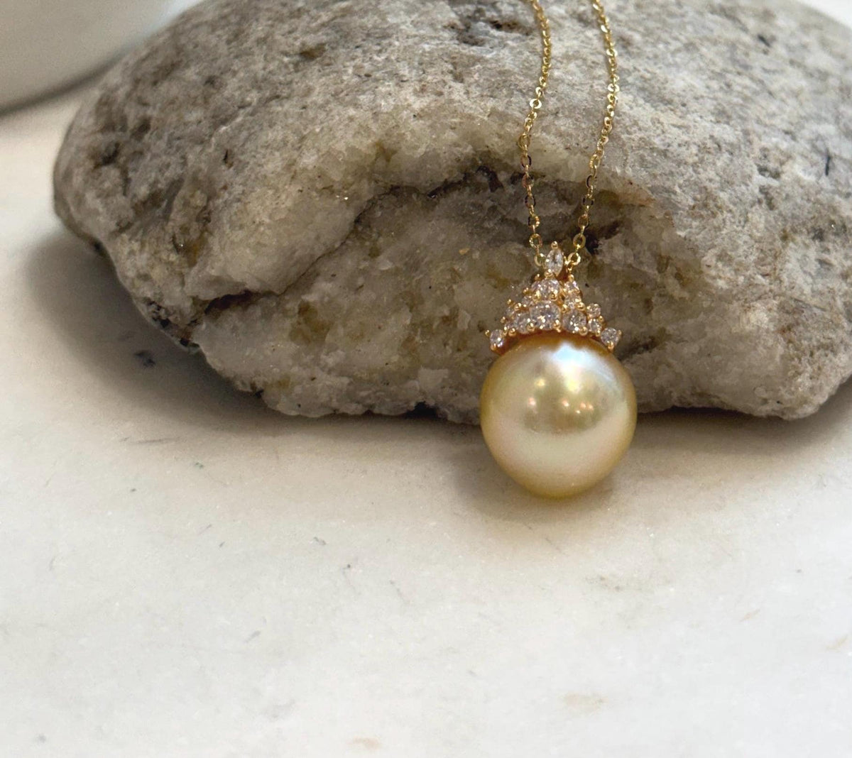 Genuine golden saltwater pearl set in a crown-style sterling silver pendant.