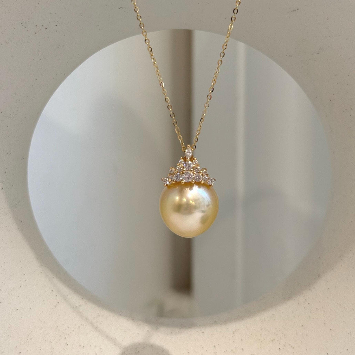 South Sea pearl crown pendant featuring extreme luster and a rich golden color.