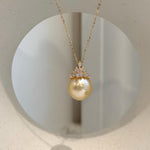 South Sea pearl crown pendant featuring extreme luster and a rich golden color.