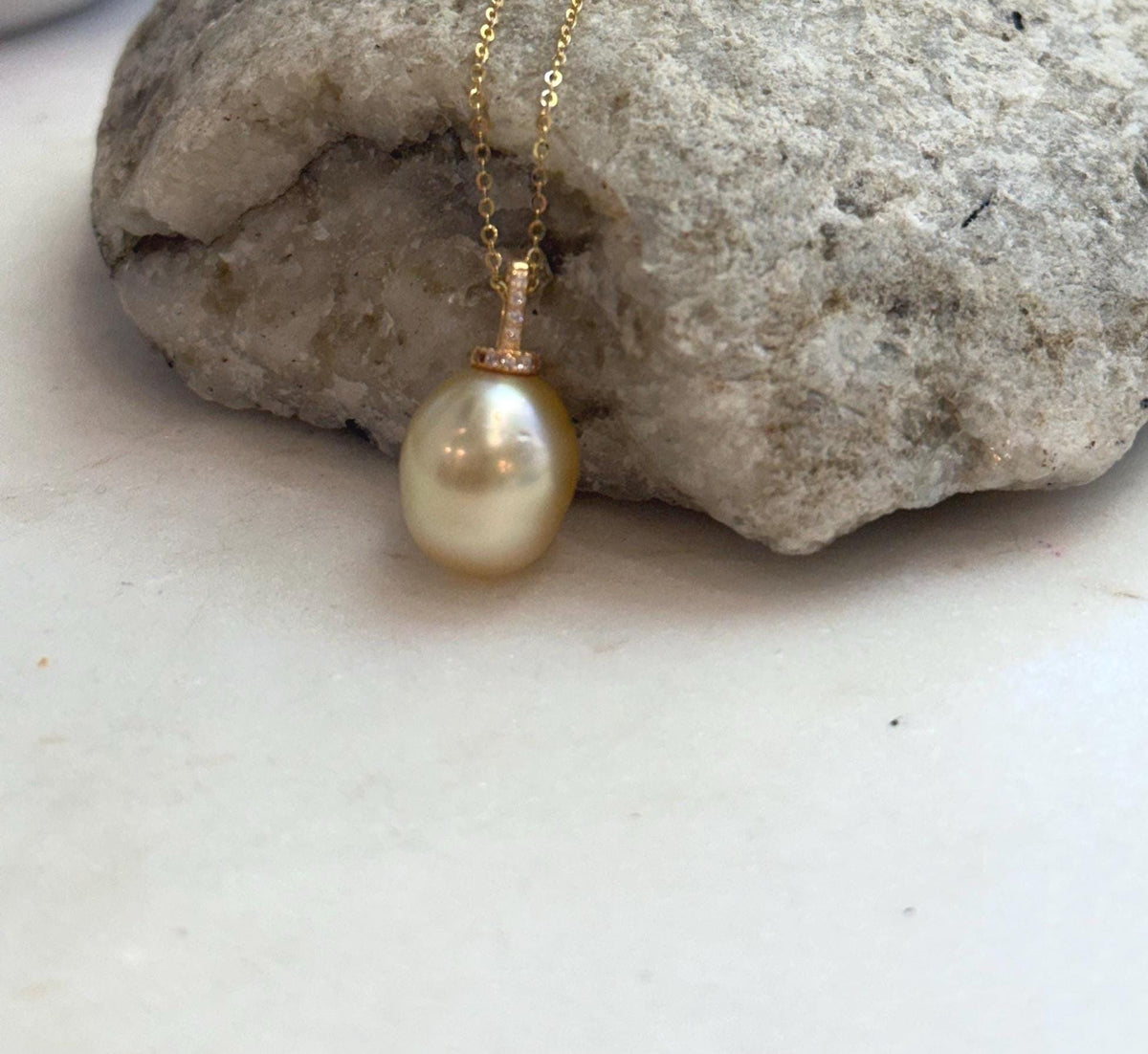 Genuine golden saltwater pearl pendant with mirror luster and iridescent overtones.