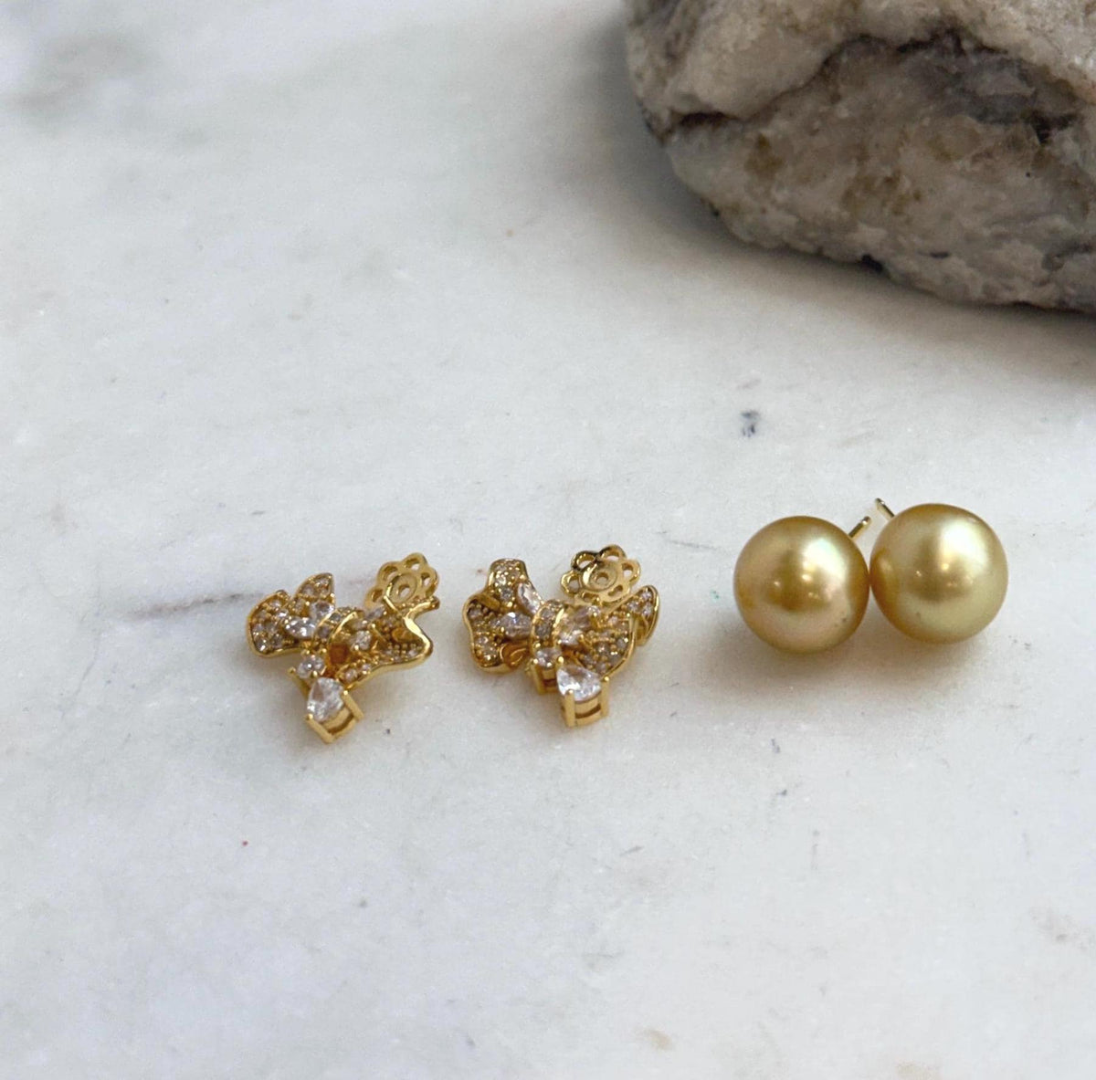 South Sea pearl stud earrings featuring rich tea gold tones and silver jackets.