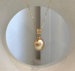 Genuine saltwater pearl pendant featuring a rich deep tea golden color.