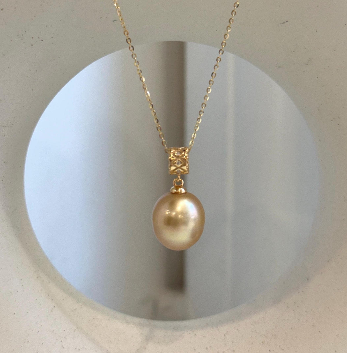 Deep tea golden pearl set in S925 silver, showing its lustrous surface.