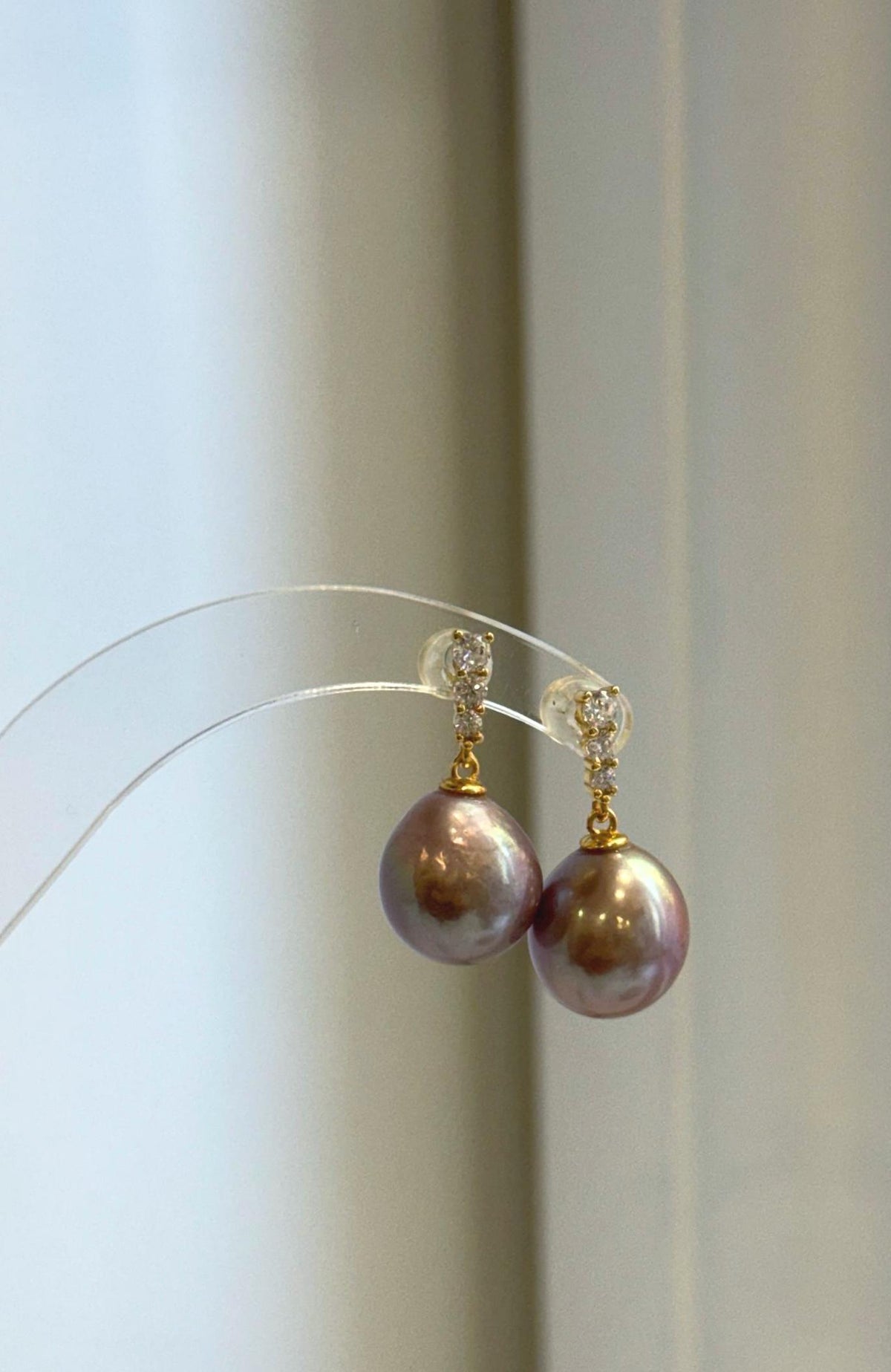 Large mauve pearl drop earrings with bright mirrored luster
