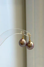 Large mauve pearl drop earrings with bright mirrored luster