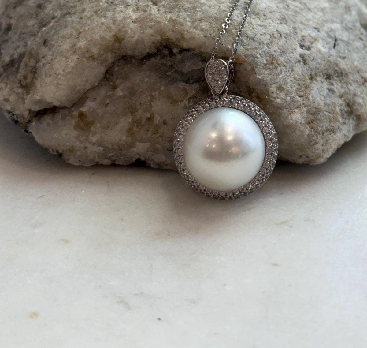 Large white saltwater pearl paired with a sterling silver pendant setting.