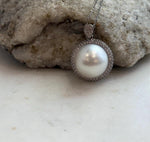 Large white saltwater pearl paired with a sterling silver pendant setting.