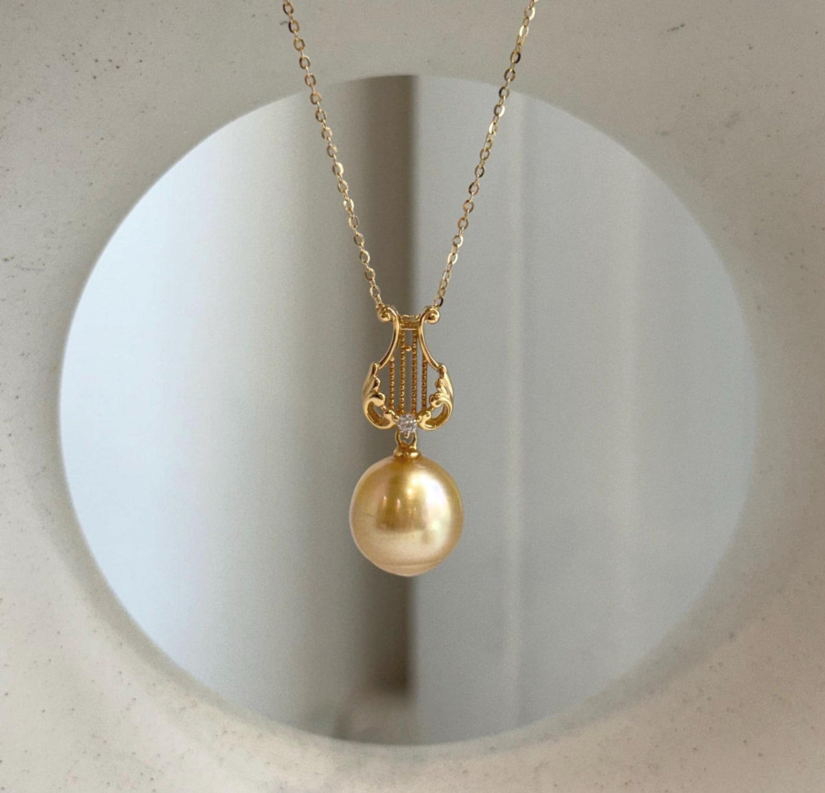 Deep tea gold South Sea pearl in a Lyra pendant setting crafted from S925 sterling silver.
