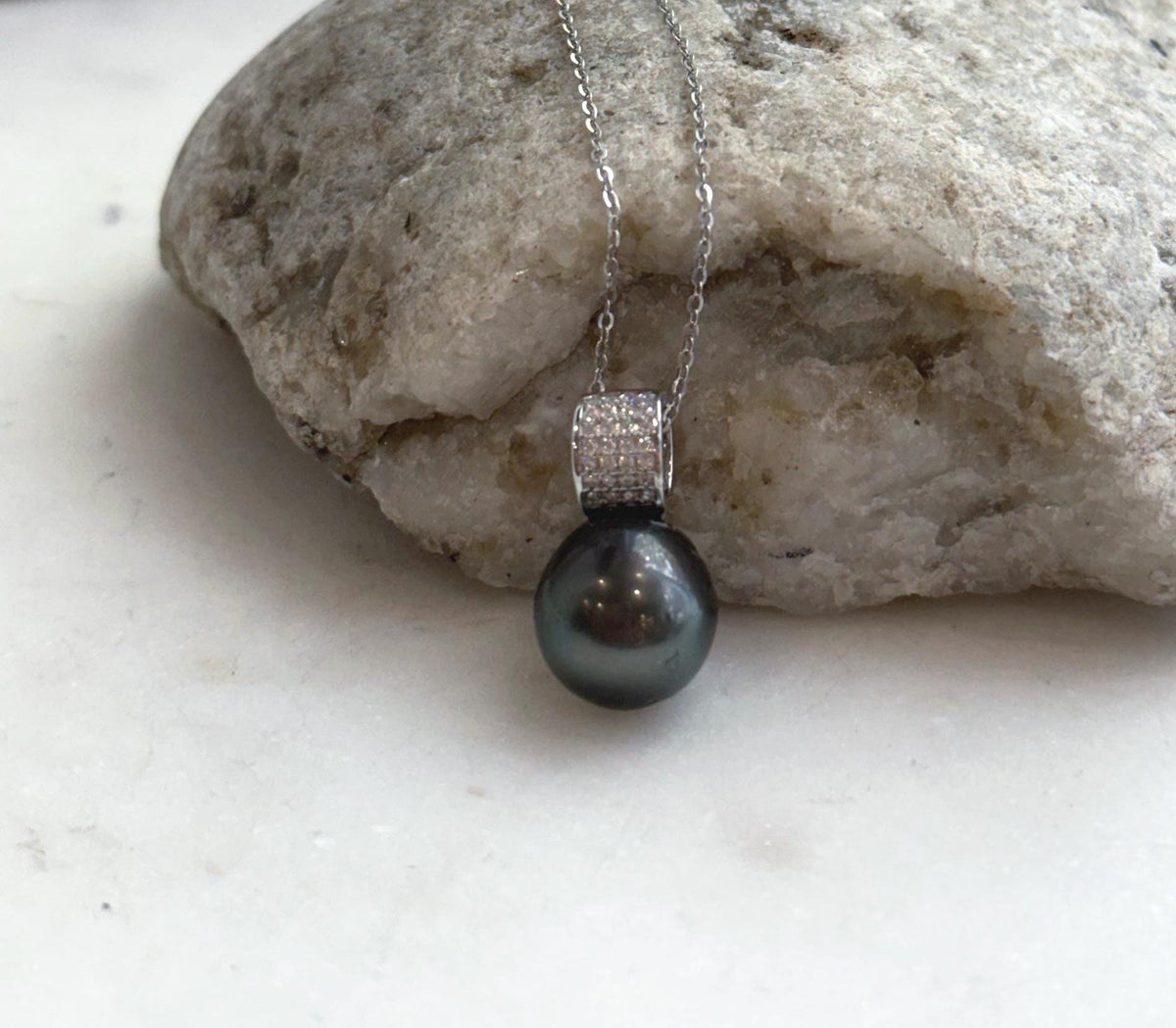Deep hunter green pearl pendant with crystal details in S925 sterling silver.