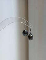 Silver hook earrings featuring dark gray pearls
