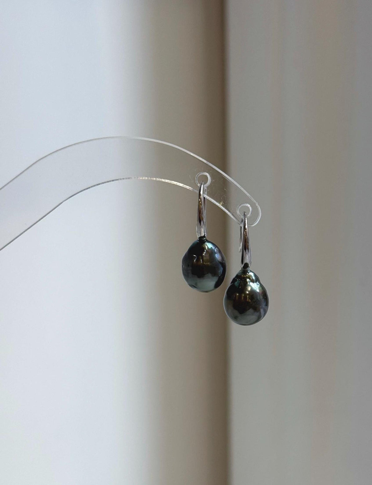 Silver hook earrings featuring dark gray pearls