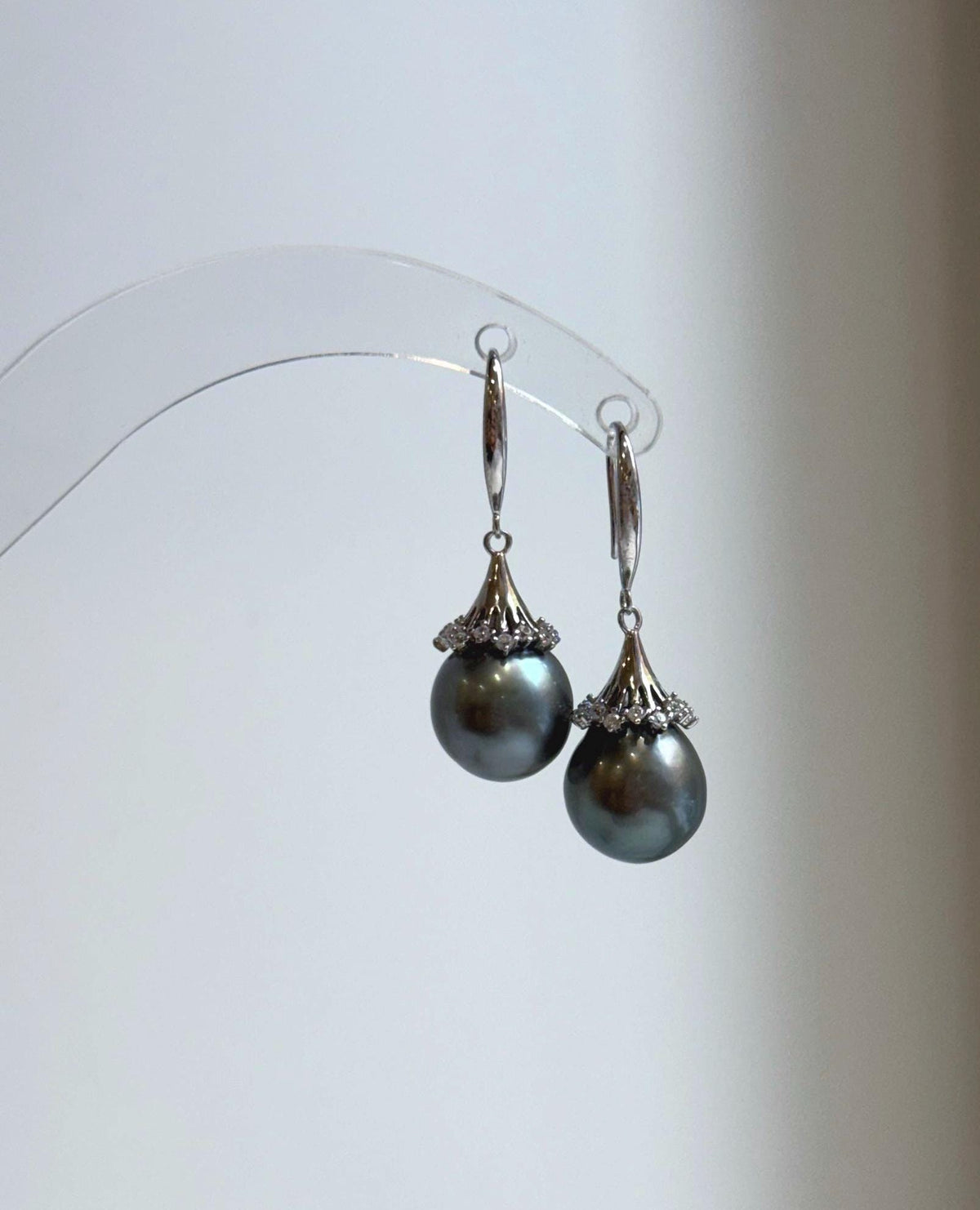 Dark gray pearls framed by delicate floral details