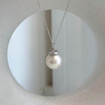 White South Sea pearl with brilliant luster beneath a botanical silver cap.