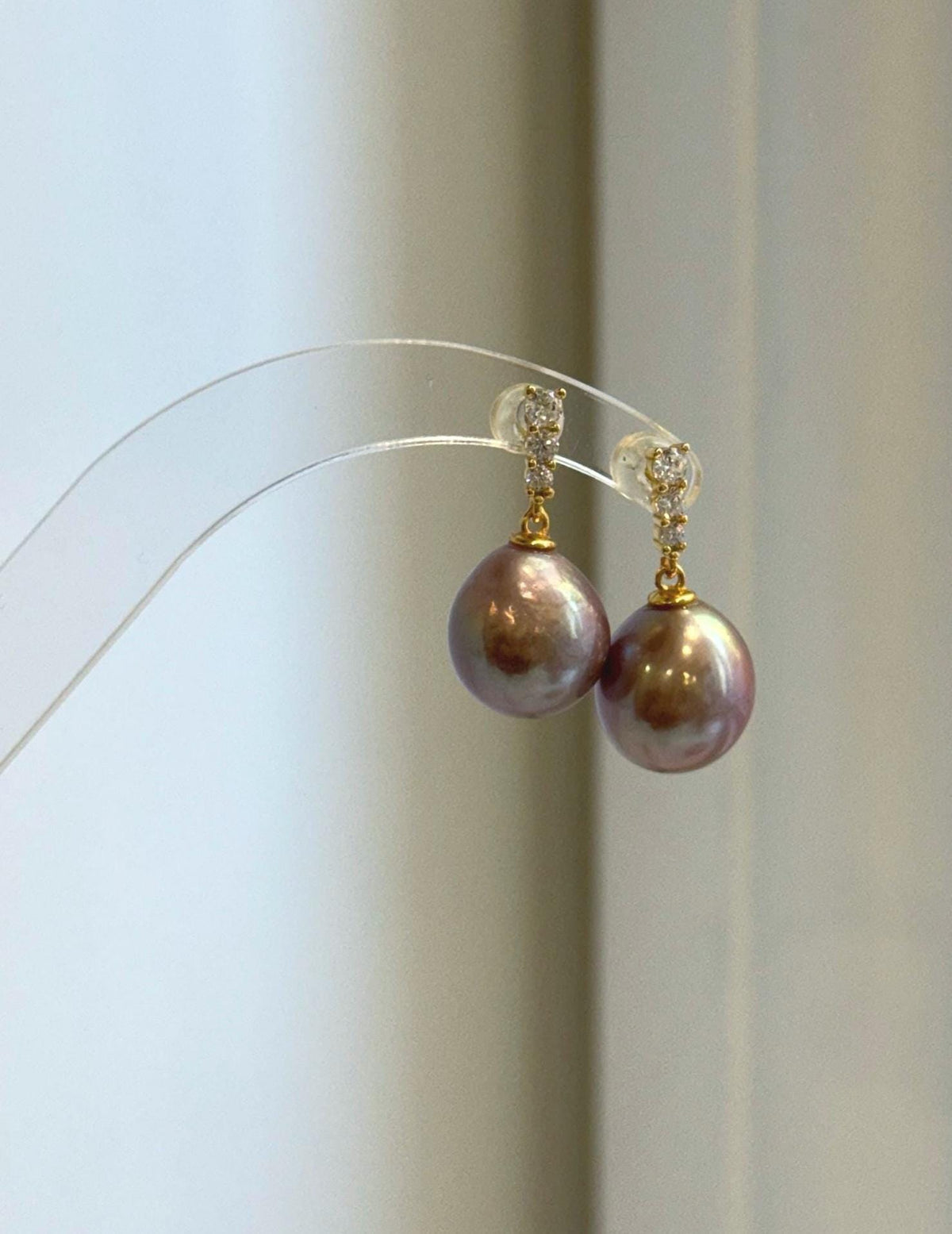 Rose mauve freshwater pearls set in S925 sterling silver earrings.