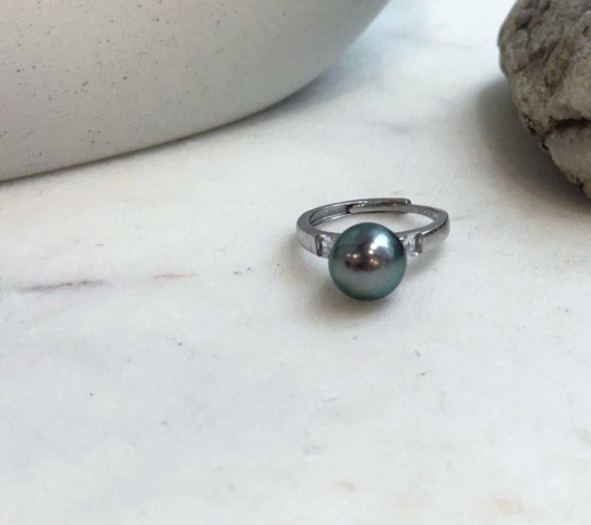 Peacock green pearl centerpiece on an adjustable sterling silver band.
