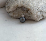 Mirror-luster Tahitian pearl necklace with a crystal-accented silver setting.