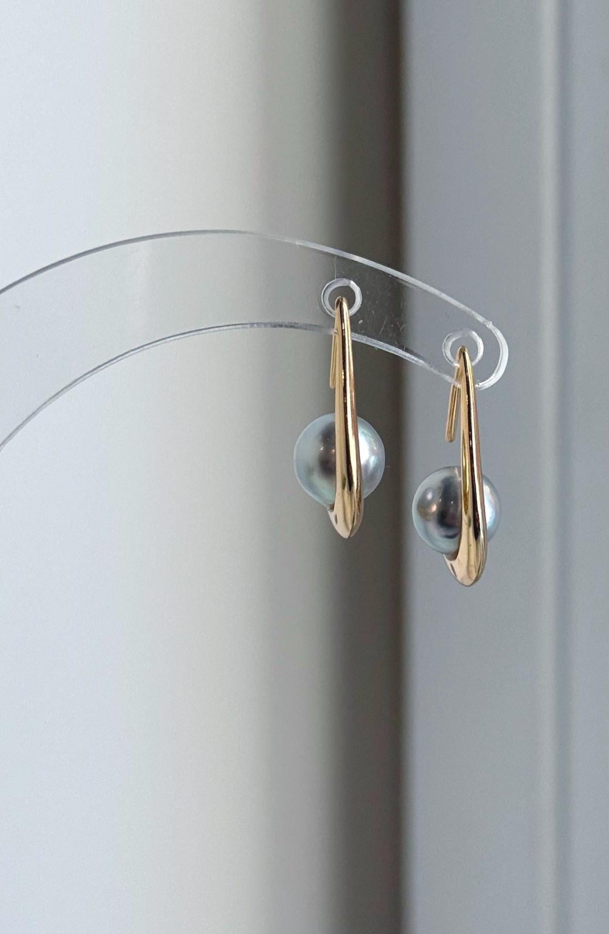 S925 sterling silver hook earrings featuring genuine silver blue saltwater pearls.