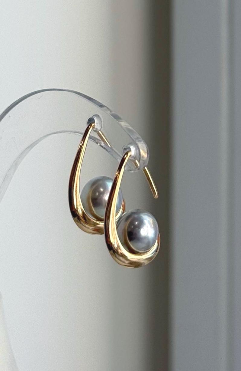 Genuine Akoya pearl drop earrings with silver blue coloring and reflective surfaces.
