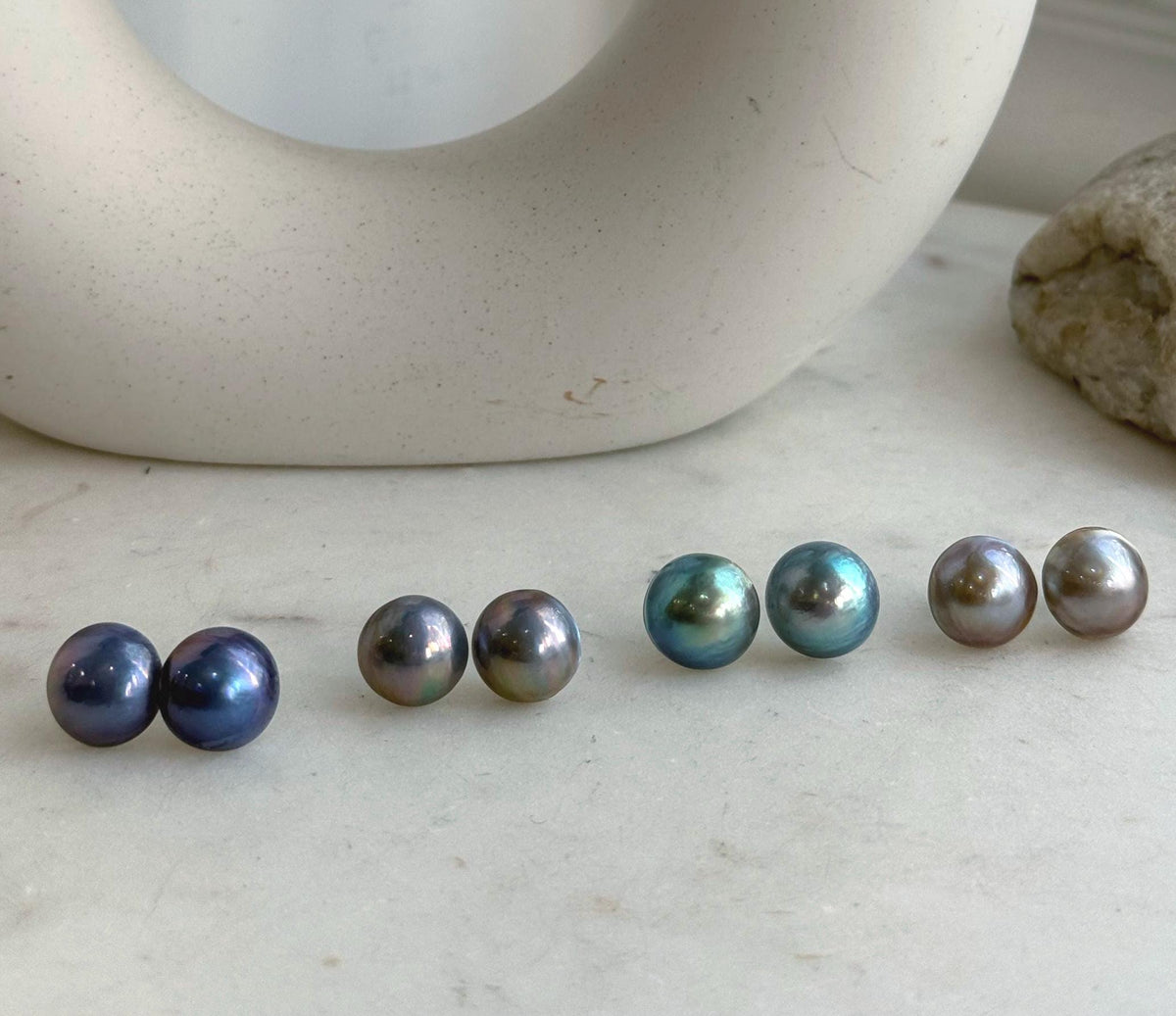 Iridescent round Mabe pearl earrings in minimalist S925 sterling silver settings.